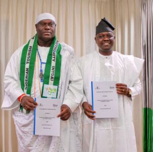 HRM, Ooni of Ife and DG, NTDA holding the Memorandum of Understanding (MOU) after the signing in Abuja